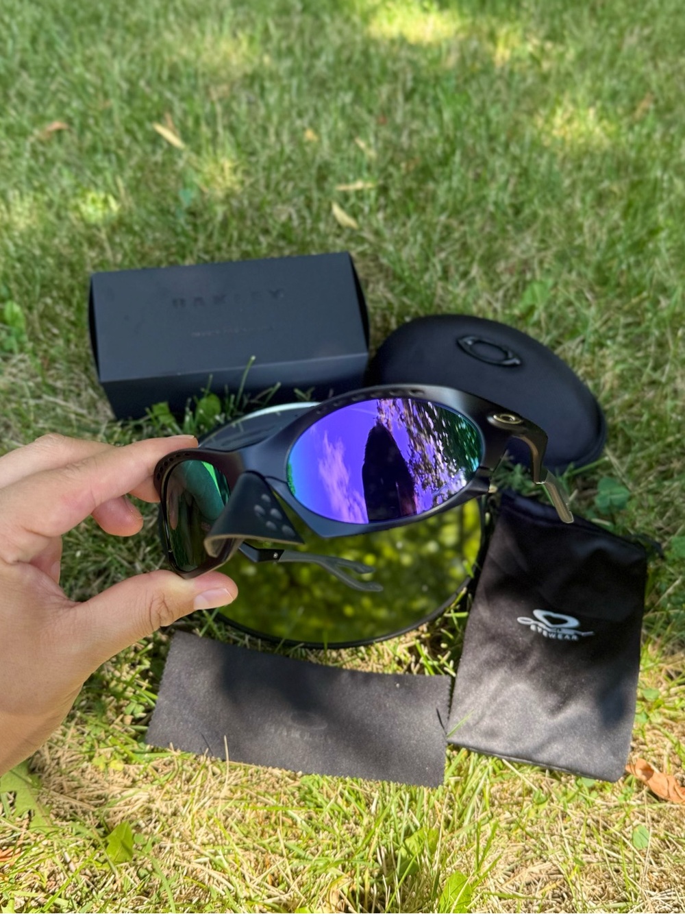 Oakley Black Frame Sunglasses with purple Reflective Lenses